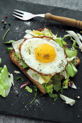 Keto breakfast. Fried eggs on toast with salad.