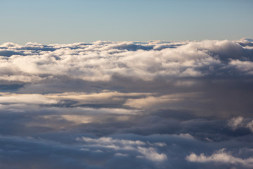 Fototapeta na wymiar Aerial view of clouds seen from the plane window