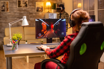 Professional video gamer female playing an online shooter game © DC Studio