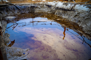 Oil and garbage pollution in the water. Selective focus with shallow depth of field. Iridescent...