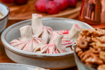Sweet khinkali with cherry, churchhela, ice cream and nuts served on a wooden table. Traditional Georgian desserts