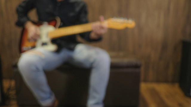 Blured Photo of young musician playing Electric Guitar, play the music instruments