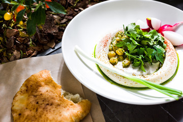 Hummus with chickpea grains. The cuisine of Tel Aviv.