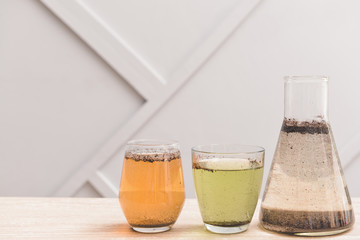 Glassware with dirty water on table