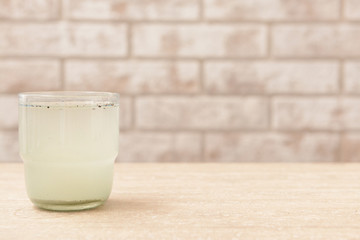 Glass of dirty water on table