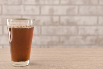 Glass of dirty water on table