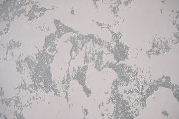 Marble background or texture. The decorative marble plaster painted on the wall mimics the natural marble surface. The combination of gray and white