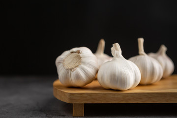 Garlic on the black cement floor and black background.