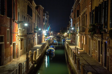 Obraz na płótnie Canvas Beautiful photo of Venice at night. Light from the lanterns erupts in the canals of Venice