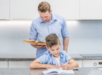Father and son do school homework at home