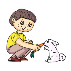 Little boy feeding rabbit with carrot on white