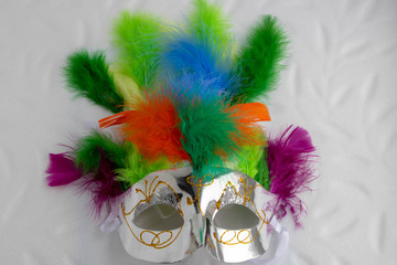 Carnival mask with multicolored feathers isolated on a white background.