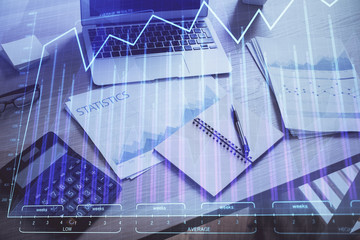 Financial graph colorful drawing and table with computer on background. Double exposure. Concept of international markets.