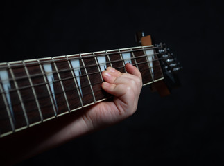 Children's hand close up learning guitar playing