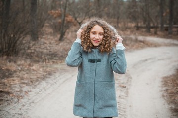 Teenage girl in in fashionable grey wool coat at park outdoor portrait