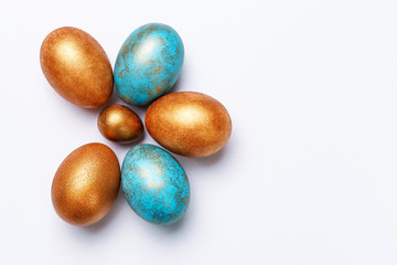 Blue and golden modern easter eggs on a white background. View from above. Isolated. Like the shape of a flower.