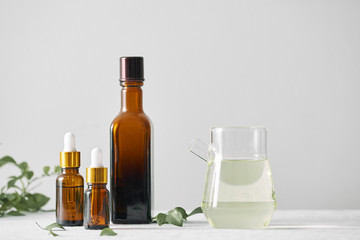 Bottles with aroma oil, medicines on wooden background. Selective focus,horizontal.