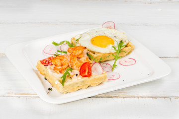 Viennese waffles with egg, tomato, radish on a white background