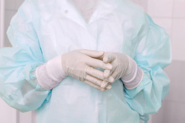 Fototapeta premium Doctor ophthalmologist surgeon is getting ready for microsurgery operation. The medical latex gloves professional safety equipment concept