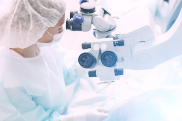 Ophthalmology operation. Surgeon's hands performing laser eye vision correction or cataract...