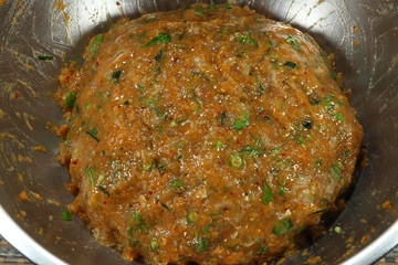 Raw marinate spicy fish cake in Thai style. Ready to fried in kitchen. Traditional street food menu in Asia. 