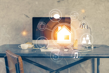 Desktop computer background in office and big town buildings hologram drawing. Double exposure....