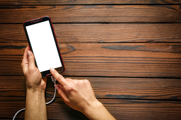 phone with hands addiction on a wooden background