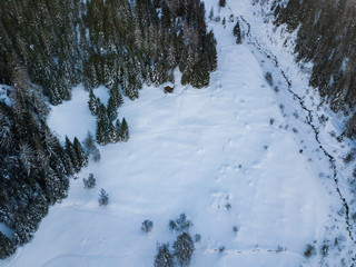Aerial view of snow covered winter landscape in rural mountain region.