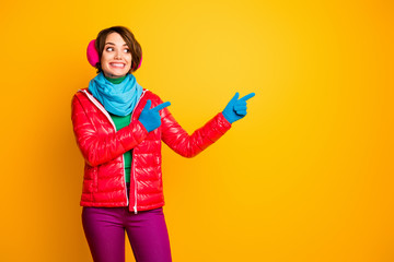 Photo of funny pretty lady indicate fingers empty space final season low prices wear casual red coat blue scarf gloves ear warmers pants isolated yellow color background © deagreez