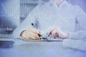 Financial chart drawn over hands taking notes background. Concept of research. Multi exposure
