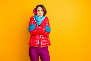 Photo of pretty traveler lady model not expect frosty weather trip shaking wear stylish casual short red overcoat blue scarf gloves ear covers pants isolated yellow color background