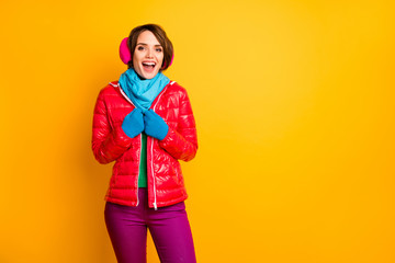 Photo of pretty traveler lady enjoy amazing winter day exciting weather wear stylish casual red overcoat blue scarf gloves pink earmuffs pants isolated yellow color background
