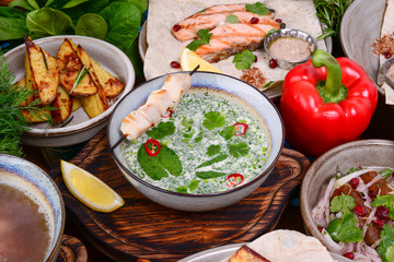 Cold soup okroshka with matzoon chicken and coriander served in a bowl with vegetables. Traditional georgian cuisine