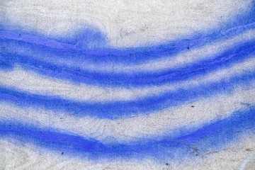 Stripes of blue paint on a wooden wall