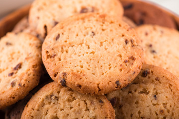 Chocolate chip cookies with milk on burlap and rustic wooden table