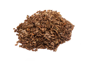 heap of carrot seeds on a white background