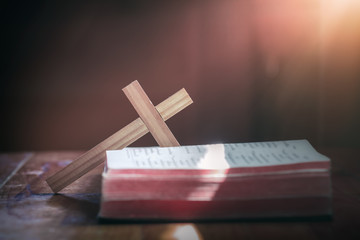 Close up the Cross on the holy Bible in morning, Close up, christian worship concept.