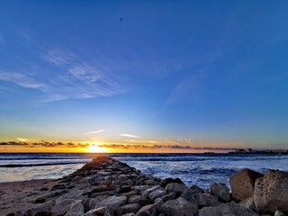 sunset on coast of sea