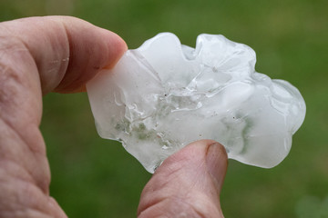 Hail stone held in hand after thunder storm