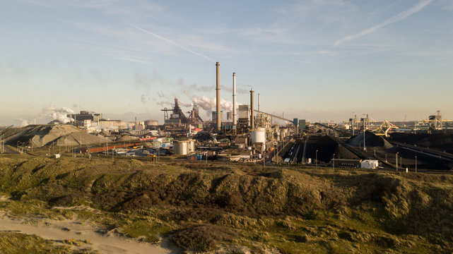 Factory Tata Steel with smoking chimneys on a sunny day, IJmuiden, The Netherlands