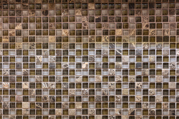 Luxury dark and golden mosaic tiles on the wall for interior or decoration in kitchen or bathroom. Room ceramic wallpaper & background in multi colors. 