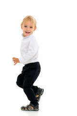 Little boy fun runs in the studio on a white background.
