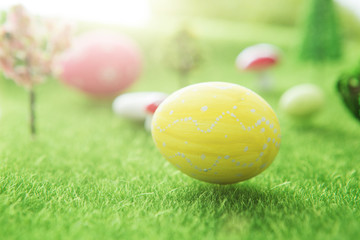 Big yellow easter egg on grass background in Dreamland or fairy world..