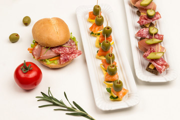 Assortment of canapes, sandwich with ham, cheese and lettuce