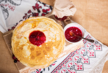 Homemade hot pancakes with jam. Rustic style, crepes close-up.
