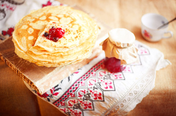 Homemade hot pancakes with jam. Rustic style, crepes close-up.