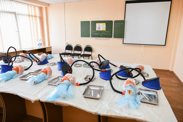 classroom for tracheotomy. head for tracheotomy practice. Training class on tracheotomy. children and surgeon.