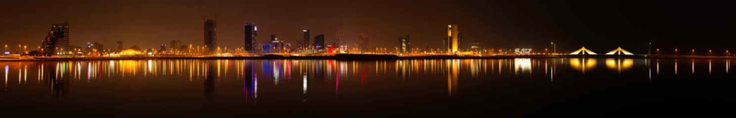 Fototapeta premium Panoramic view of Bahrain skyline at night with iconic buildings, December 24 2019, Manama, Bahrain