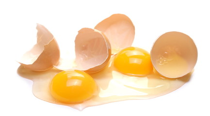 Egg whites and yolk with cracked eggshells, isolated on white background