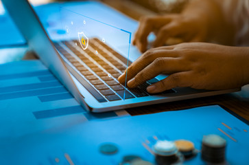 Person using a laptop computer with technology cybersecurity and privacy concept. protection and safe data for global network security.